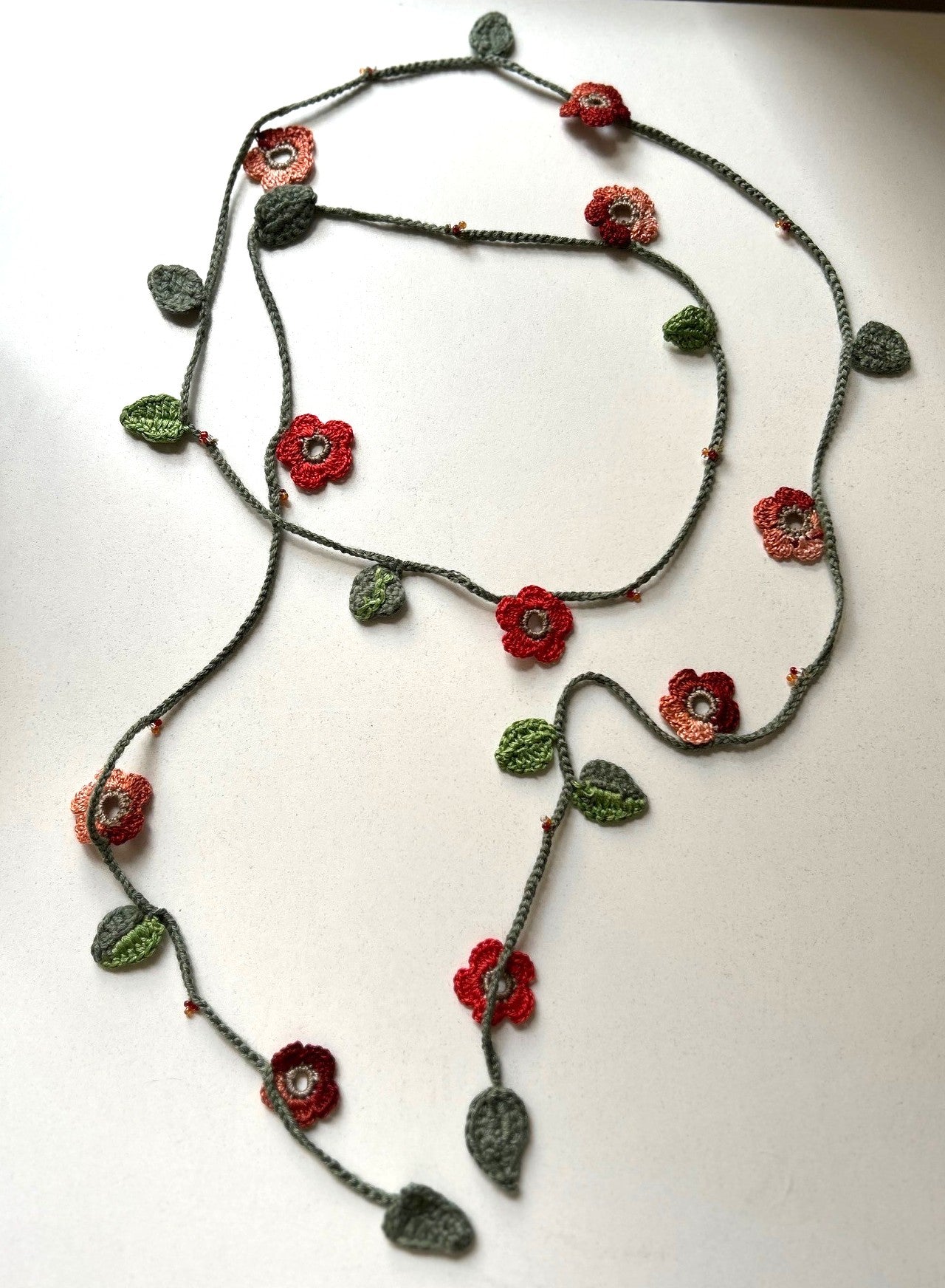 Virkat halsband/dekorband med orangemelerade blommor