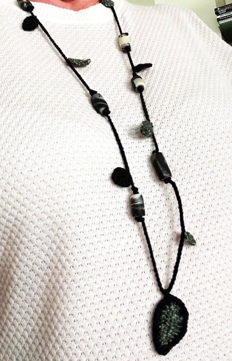 Virkat halsband med gröna och svarta blad